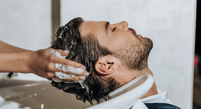 close up partial view of hairstylist washing hair 2023 11 27 05 28 02 utc 2